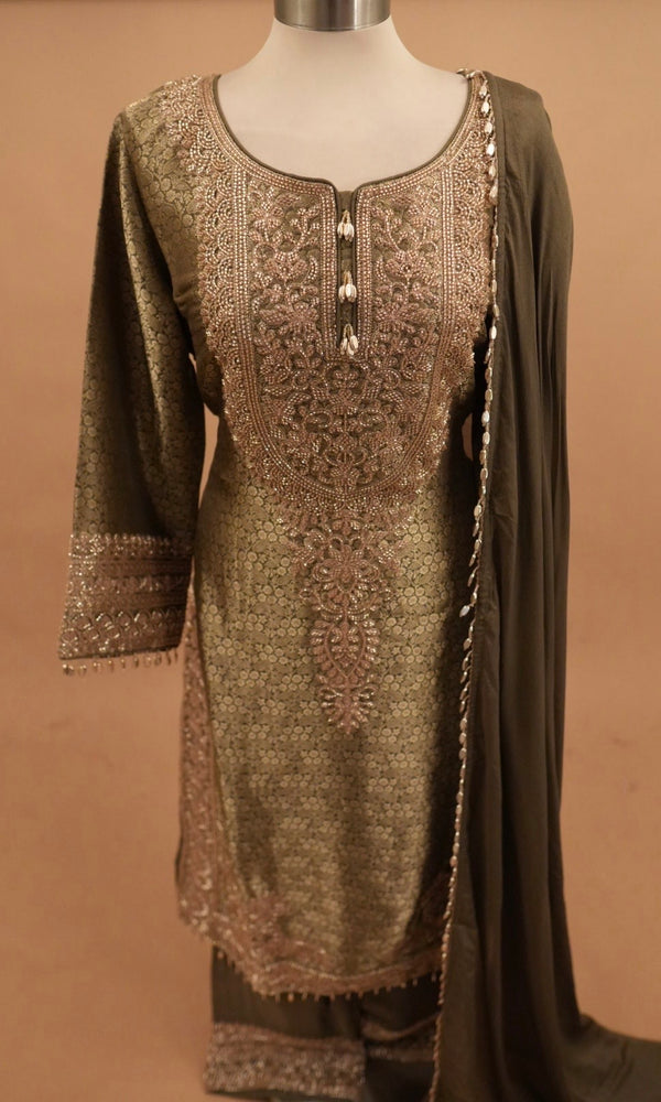 Green embroidered kurta on a mannequin against a brown background